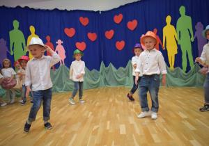 chłopcy tańczą w kapeluszach