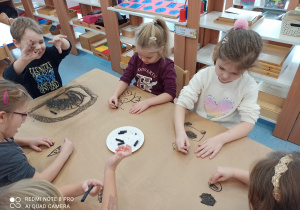 dzieci malują węglem