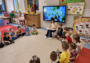Przedszkolaki słuchają czytanej przez Gabrysię bajki