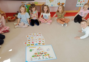 dzieci prezentują ułożoną piramidę zdrowego żywienia