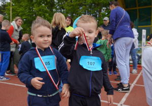 chłopiec pokazuje swój medal