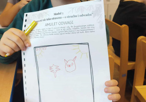 Chłopiec prezentuje swój amulet