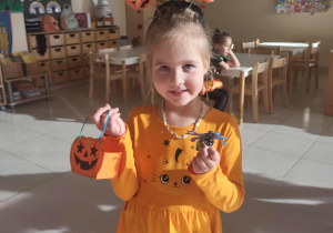 dziewczynka prezentuje wykonaną dyniową torebkę