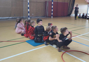 dzieci siedzą na podłodze