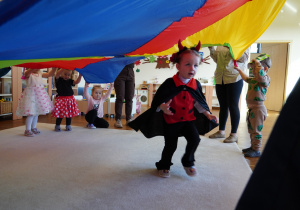 dziewczynka przebiega pod chustą