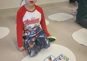 chłopiec prezentuje ułożony wyraz