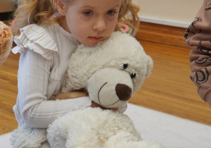 dziewczynka przytula misia