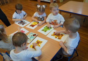 dzieci malują misie farbami