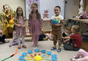 dzieci chodzą wokół urodzinowego słoneczka