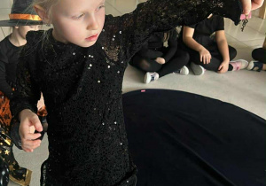 dziewczynka pokazuje wylosowany klucz z odpowiednim kolorem kartki