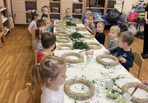 dzieci siedzą przy stolikach