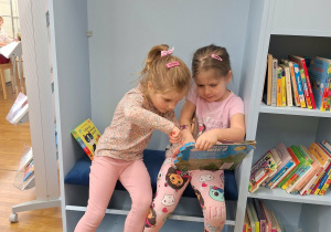 dziewczynki oglądają książki