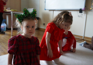 dziewczynki siedzą na dywanie