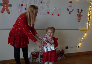 pani wręcza dziewczynce prezent