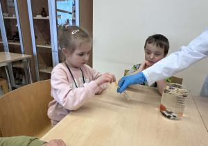 dziewczynka wykonuję eksperyment z papierkiem i octem