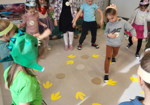 dzieci chodzą po śladach dinozaurów