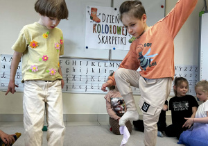 Chłopcy podnoszą skarpetki za pomocą palców u stóp