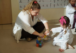 dziewczynka wsypuje proszek d o balona