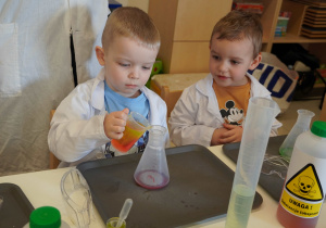 chłopiec nalewa płyn do pojemnika