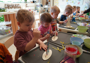 Trzylatki z precyzją malują drewniane zające