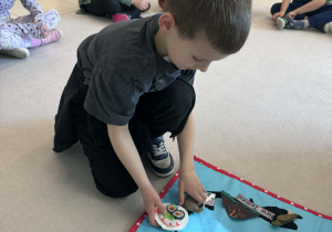 chłopiec przyczepia shusi na mapie Nowej Zelandii