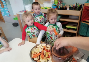 Dzieci wkładają marchewkę